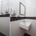 Sindbad Hotel Kuala Lumpur bathroom with toilet, shower, sink and wall mirror