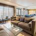 Best Western Hotel Würzburg Sued lounge with sofas, glass coffee table and small dining area in Wurzburg