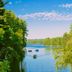 Lakeside Motel in Wisconsin Dells with serene lake view framed by trees and boats