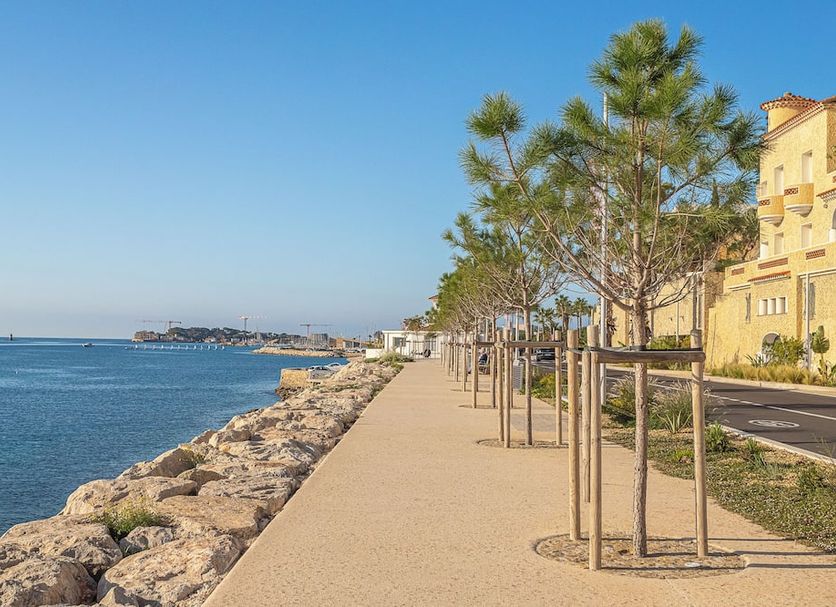 Hotel de la Baie in Bandol with seafront promenade, rocky shoreline, and ocean view