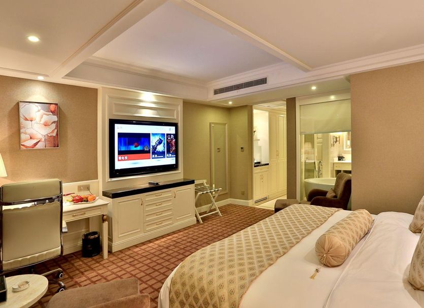 Zhong'an Huana Holiday Hotel in Hangzhou guest room with TV, desk, chair and visible bathroom
