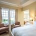 The Inn At Cobble Beach in Balmy Beach guest room with four-poster bed, sitting area and lake view