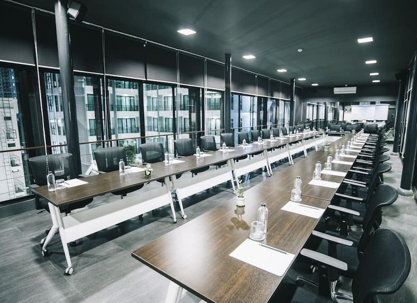 Marine Beach Hotel Pattaya in Jomtien meeting room with long conference tables and black chairs