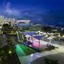 Sonesta Maho Beach Resort Casino & Spa in Lowlands at dusk, with lit resort grounds and shaded outdoor pavilion
