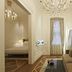 The Stay Galata in Istanbul: elegant suite with chandelier, sofa, mirror and bedroom doorway