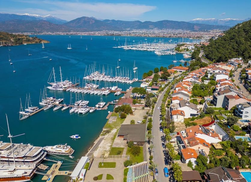 Cennet Life Otel in Fethiye with marina and bay views beside a hillside neighborhood