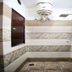 Oyo 8959 New Dk Palace Chandigarh bathroom with shower area, wall tiles, and hanging towels