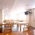 Lodge Koropokkuru in Niseko dining room with wooden tables, chairs, and large bright windows