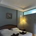 Aonang Sr Bungalow in Ao Nang guest room with double bed, bedside lamp and high window