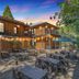 The Groveland Hotel in Groveland courtyard with outdoor dining tables and balcony rooms at dusk