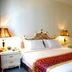 Guohao Hotel in Shijiazhuang guest room with a double bed, bedside lamps, and ornate headboard