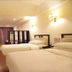 Chengdu Tianfu Lidu Hotel in Chengdu room with two beds, wood floor, wall-mounted TV and curtained window
