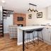 Broom Hall Inn in Alcester: stylish suite with spiral staircase, kitchen island, bar stools and brick feature wall