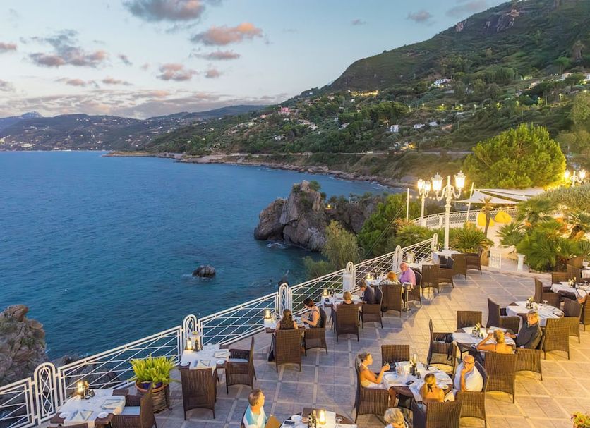 Hotel Kalura in Cefalù with seaside terrace dining and panoramic Mediterranean coastal views