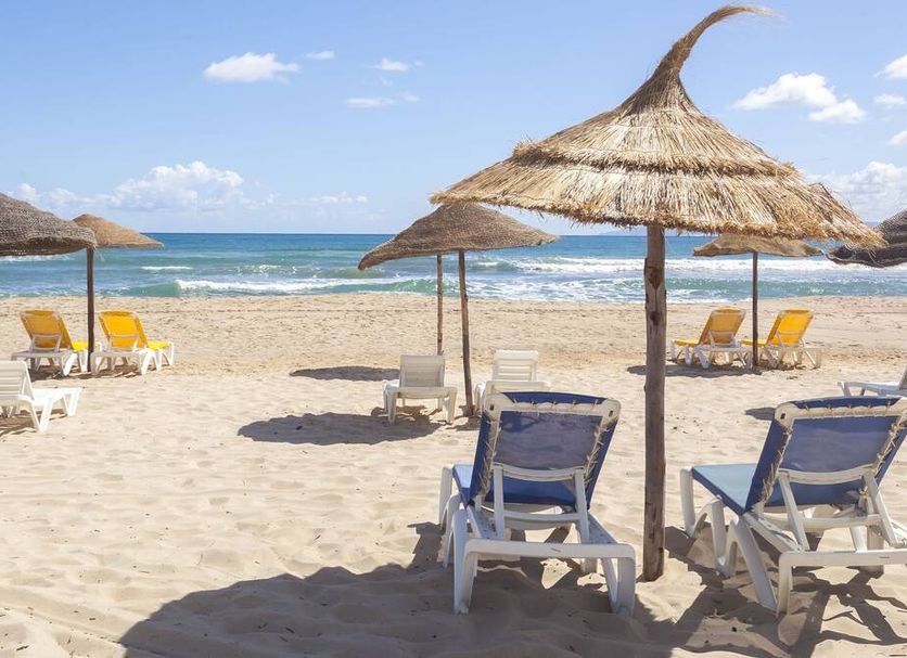 Itropika Hôtel in Tabarka: beach loungers and straw umbrellas on a sandy seaside beach