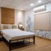 The Goose House Ubon room in Ubon Ratchathani with bed, sofa, wall art and wood accent wall