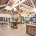 Mirah Hotel & Resort Banyuwangi lobby with high wooden ceiling, seating area and front desk