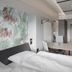 Valo Hotel & Work Helsinki guest room with bed, workspace, wall-mounted TV and minimalist decor