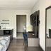 Studio 6 Suites Lafayette guest room with bed, desk, wall-mounted TV and kitchenette area