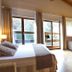 Reserva del Saja Hotel & Spa room with balcony doors, spa tub, and wood-beamed ceiling in Renedo de Cabuérniga