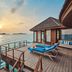 Anantara Dhigu Maldives Resort overwater deck with sun loungers and ocean sunset view in Dhigufinolhu
