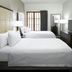 Homewood Suites by Hilton Mont-Tremblant Resort room with two white beds, TV, and window view