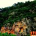 Dalyan Terrace Hotel in Dalyan, Mugla, with cliffside rock-cut tombs beneath a green hillside