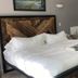 Pikes Peak Paradise Bed and Breakfast in Woodland Park: rustic bed, jacuzzi tub, and bright guest room