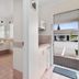 Asure Prince Motor Lodge in Taupo: bathroom with vanity and open doorway to parking area