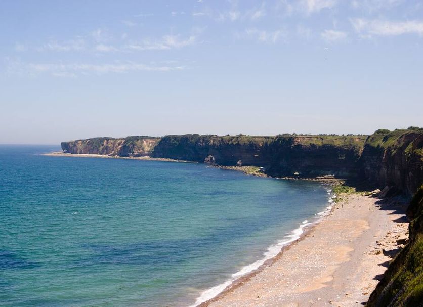Best Western Hotel de la plage Normandie in Asnelles with a sandy beach and coastal cliff view