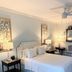 1842 Inn in Macon guest room with queen bed, bedside lamps, ceiling fan and patterned wall art