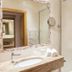 Das Zimmerbräu bathroom with sink, mirror, towel rack and glass shower in Sankt Wolfgang im Salzkammergut