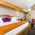 Super 8 by Wyndham Lewistown guest room with king bed and vanity area in Lewistown