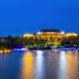 Liuhu Hotel (Hot Spring Garden Hotel) in Dezhou, lit waterfront hotel with reflections at night