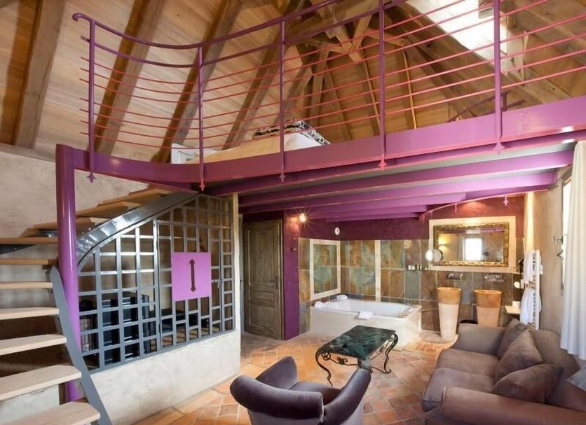 Hôtel-Spa Le Saint Cirq loft-style suite in Bouzies with mezzanine, spiral stairs, and tiled bathroom