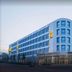 Staycity Aparthotels Heidelberg exterior in Heidelberg with modern corner facade at dusk