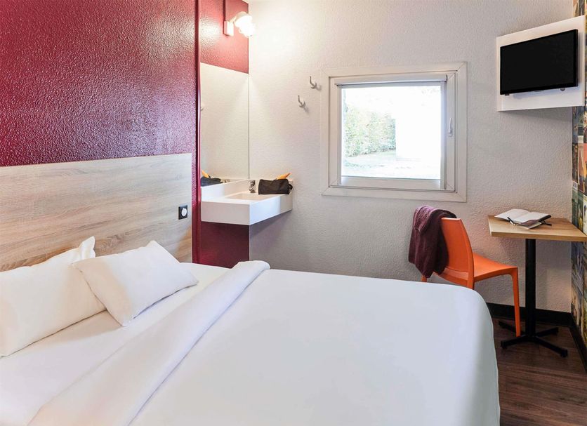 Hotelf1 Bordeaux Nord Lormont room with double bed, sink, window, desk and wall-mounted TV