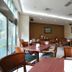The Koos Hotel in Xindian District dining area with wooden tables and chairs beside large windows