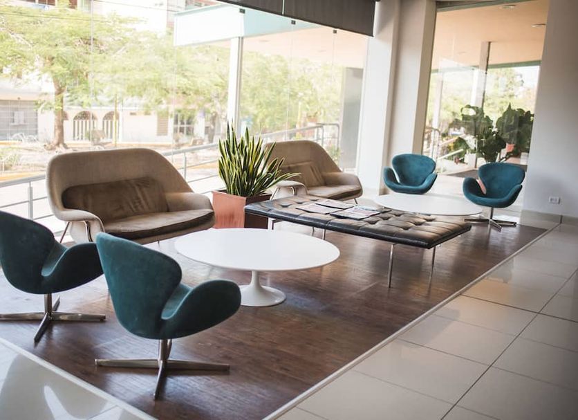 Wyndham Costa del Sol Pucallpa lobby seating area with chairs, sofas, tables, and large windows in Pucallpa