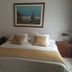 Hotel Bolivar Plaza room in Manizales with double bed, bedside tables and framed wall art
