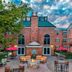 Residence Inn by Marriott West Orange courtyard with fire pit, patio seating, and red umbrellas
