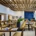 JW Marriott St. Maarten Beach Resort & Spa restaurant with wood-slat ceiling, blue accent wall, and dining tables