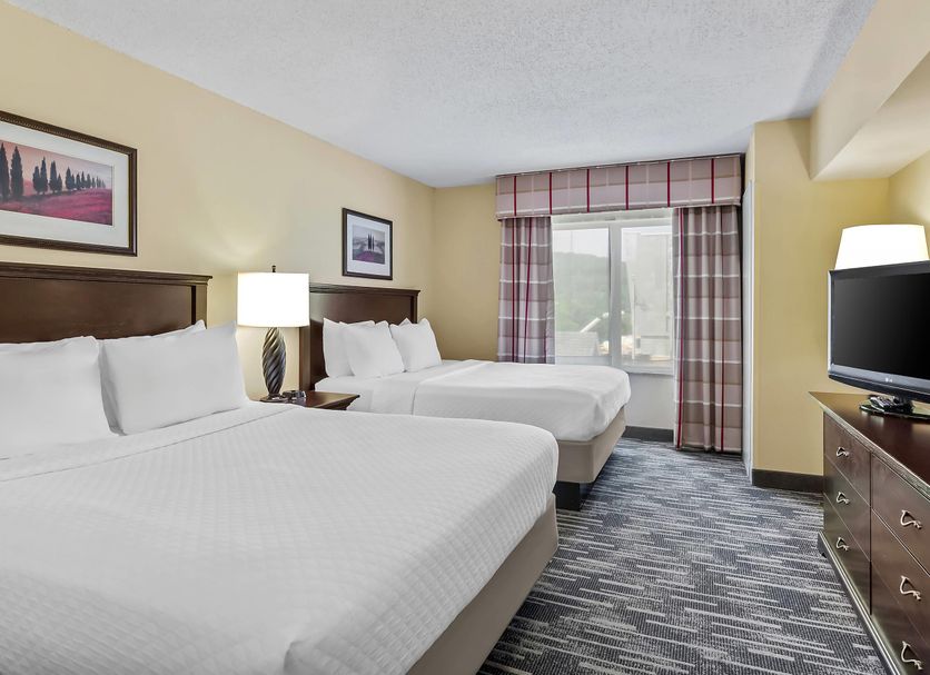 Country Inn & Suites by Radisson Princeton, WV guest room with two double beds and window view