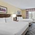 Country Inn & Suites by Radisson Princeton, WV guest room with two double beds and window view
