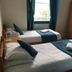The Kings Arms London room with two single beds, teal accents and window light