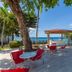 Sosua By The Sea in Sosúa: poolside terrace with red chairs and ocean view