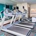 Fairfield Inn & Suites by Marriott Galesburg fitness room with treadmills, TV, mirrors and exercise bike