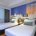 Citadines Sukhumvit 11 Bangkok room with two twin beds and city mural in Bangkok