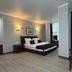 Aria Hotel Chisinau in Chisinau guest room with king bed, seating area and floor-to-ceiling curtains
