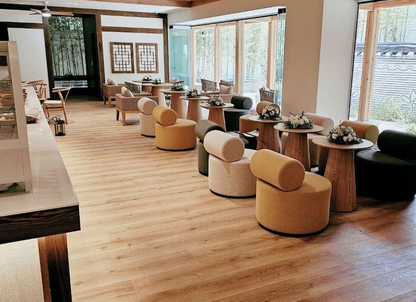 Hanok Hotel Daam in Seoul lounge with round chairs, wooden tables, and large windows